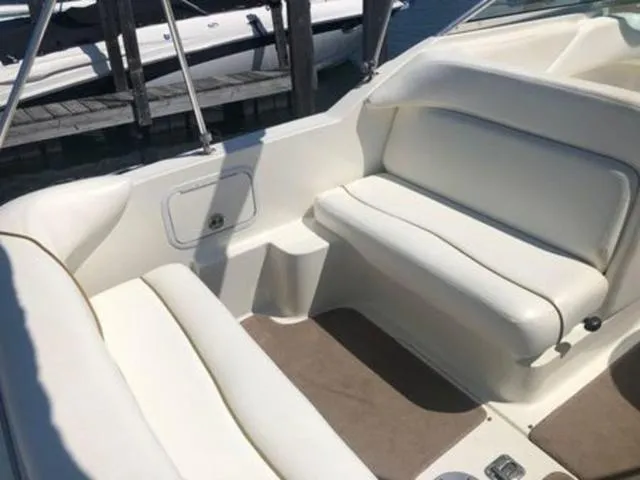 Slide: The Image of 2003 Sea Ray 260 Sundancer boat interior with white seating and beige flooring. - 6