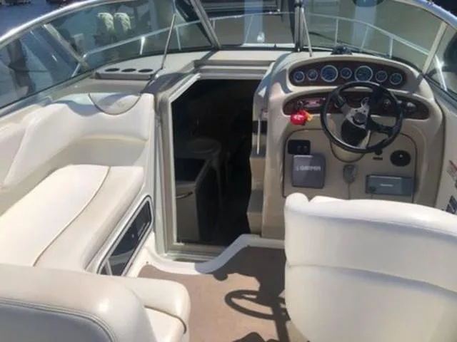 Slide: The Image of Interior of 2003 Sea Ray 260 Sundancer boat with steering wheel and seating. - 8