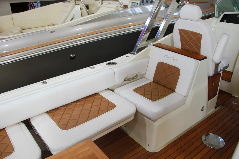 Slide: The Image of 2019 Chris-Craft Calypso 30 boat interior with luxurious tan and white seating. - 12