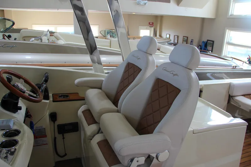 Slide: The Image of 2019 Chris-Craft Calypso 30 interior with luxurious seating and steering wheel. - 17