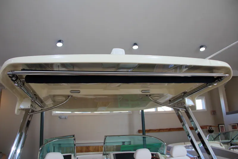 Slide: The Image of 2019 Chris-Craft Calypso 30 boat with sleek hardtop design in showroom. - 18