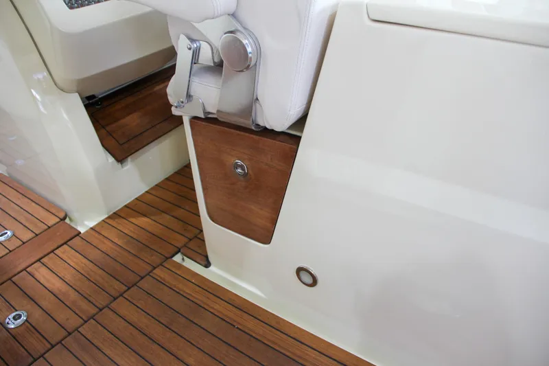 Slide: The Image of 2019 Chris-Craft Calypso 30 interior with wooden flooring and storage compartment. - 19