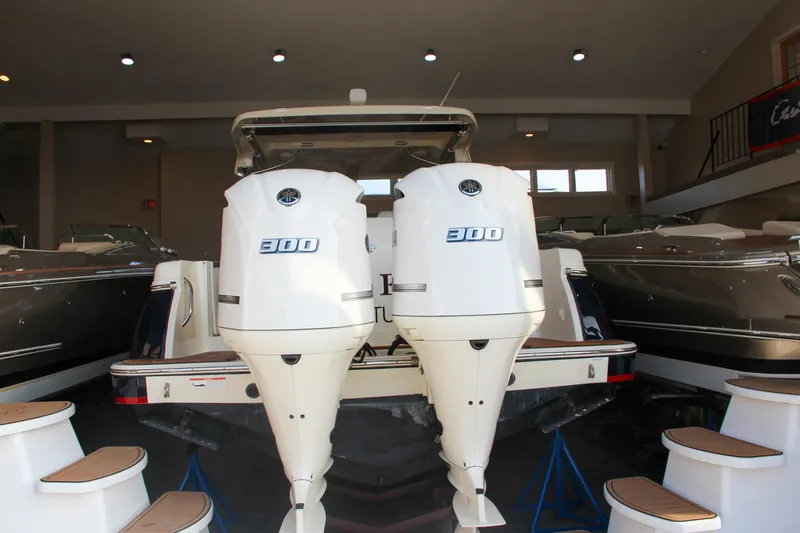 Slide: The Image of 2019 Chris-Craft Calypso 30 with twin 300 horsepower engines in showroom. - 2