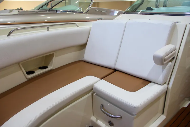 Slide: The Image of 2019 Chris-Craft Calypso 30 boat interior with white and brown seating. - 28