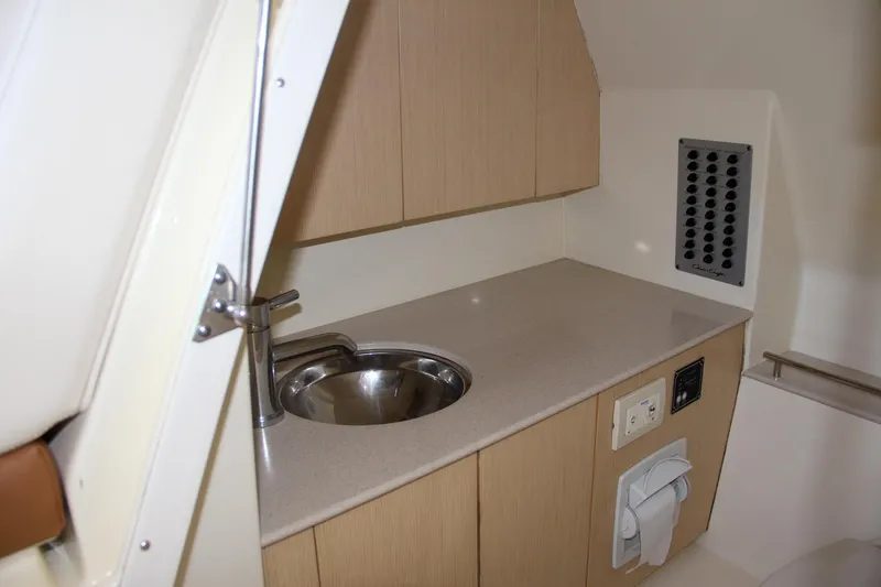 Slide: The Image of 2019 Chris-Craft Calypso 30 boat interior with sink and cabinetry. - 33