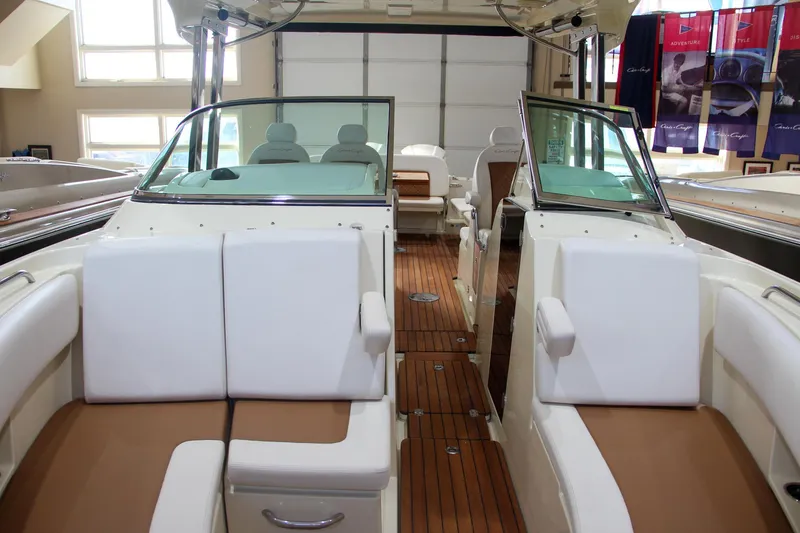 Slide: The Image of 2019 Chris-Craft Calypso 30 interior with teak flooring and white seating. - 34
