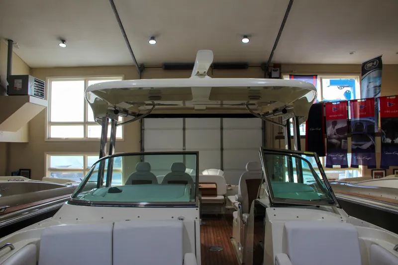 Slide: The Image of 2019 Chris-Craft Calypso 30 boat in showroom, featuring sleek design and spacious interior. - 35