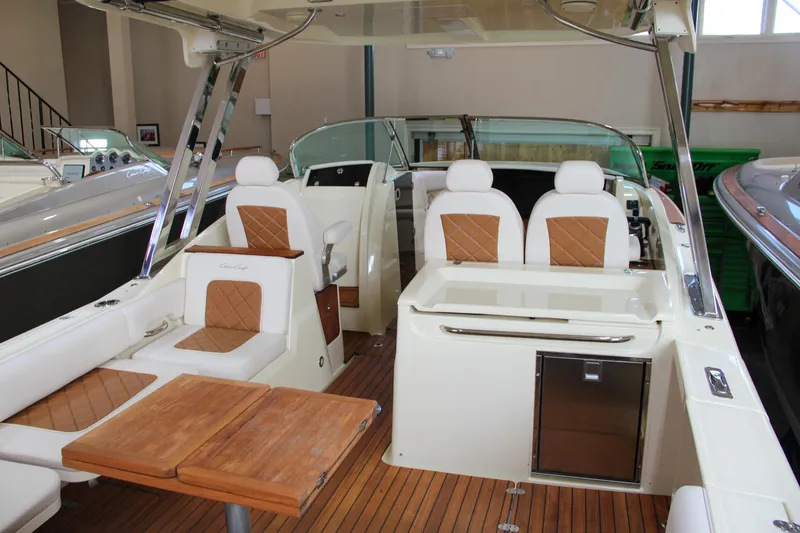 Slide: The Image of 2019 Chris-Craft Calypso 30 boat interior with teak flooring and cushioned seating. - 36