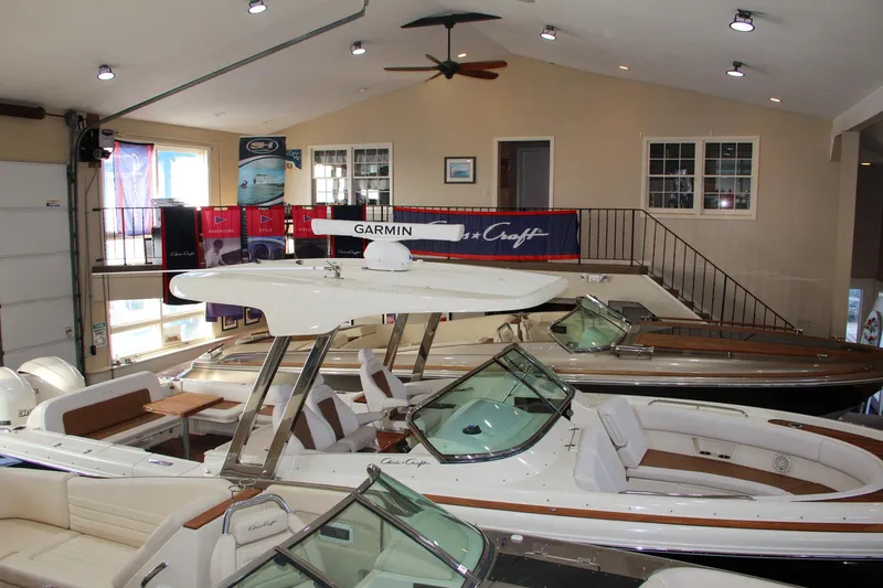 Slide: The Image of 2019 Chris-Craft Calypso 30 boats displayed in a showroom. - 37