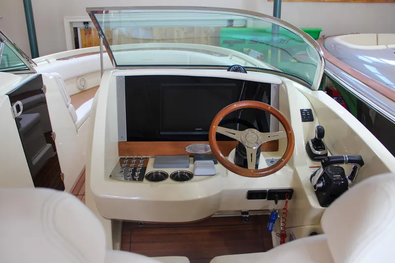 Slide: The Image of 2019 Chris-Craft Calypso 30 boat cockpit with steering wheel and controls. - 4