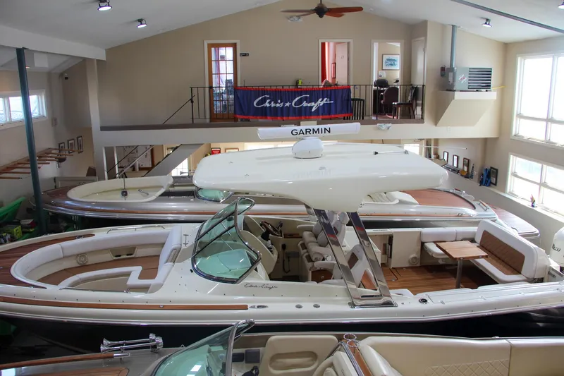 Slide: The Image of 2019 Chris-Craft Calypso 30 boat in showroom, featuring sleek design and spacious interior. - 40