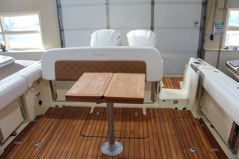 Slide: The Image of 2019 Chris-Craft Calypso 30 boat interior with wooden deck and foldable table. - 8