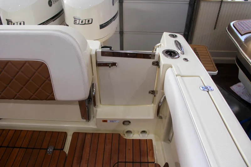 Slide: The Image of 2019 Chris-Craft Calypso 30 boat interior with teak flooring and leather seating. - 9