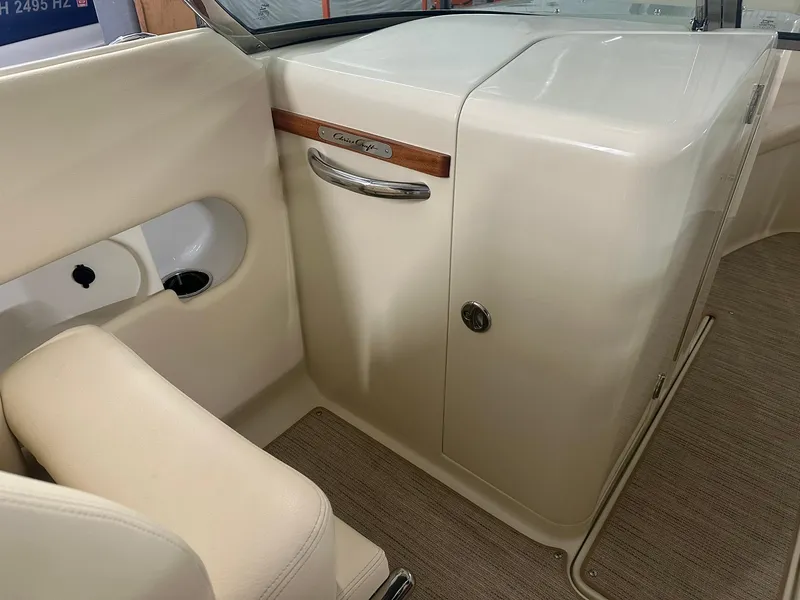 Slide: The Image of Interior of 2025 Chris-Craft Launch 27, featuring elegant beige seating and wood accents. - 11