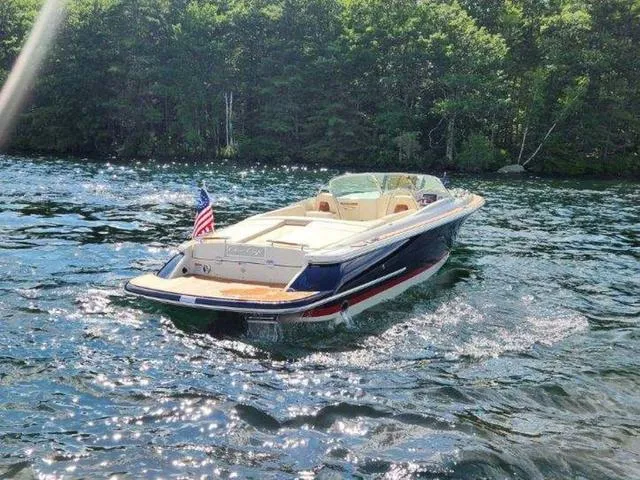 Slide: The Image of 2025 Chris-Craft Launch 27 boat cruising on a sunny lake with forest backdrop. - 6