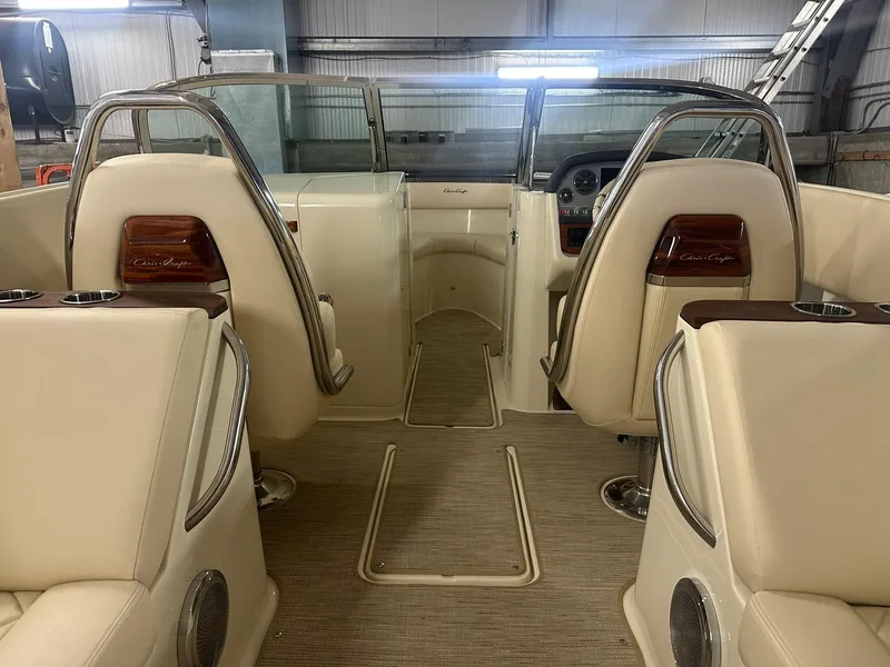 Slide: The Image of 2025 Chris-Craft Launch 27 interior with beige seating and elegant design. - 8