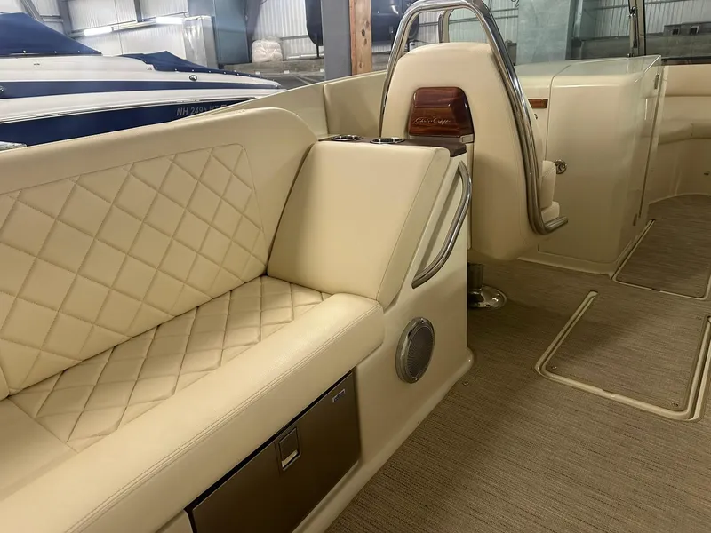 Slide: The Image of 2025 Chris-Craft Launch 27 interior with beige quilted seating and elegant design. - 9