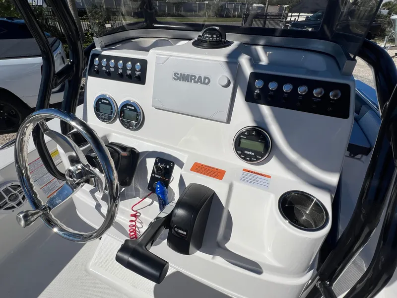 Slide: The Image of 2025 Robalo 206 Cayman boat dashboard with steering wheel and controls. - 14