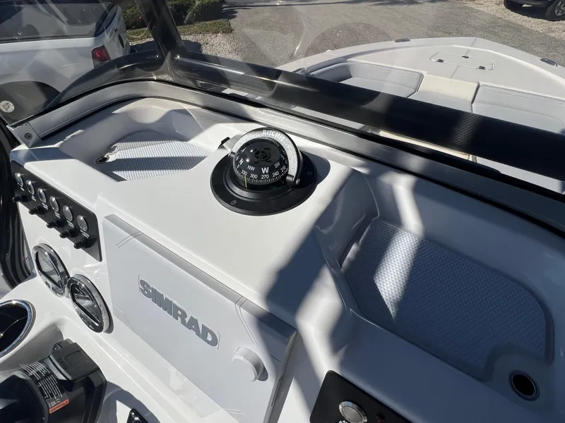 Slide: The Image of 2025 Robalo 206 Cayman boat dashboard with compass and Simrad electronics. - 17