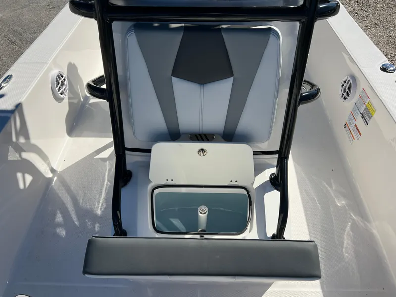 Slide: The Image of 2025 Robalo 206 Cayman boat interior with seating and storage compartment. - 19