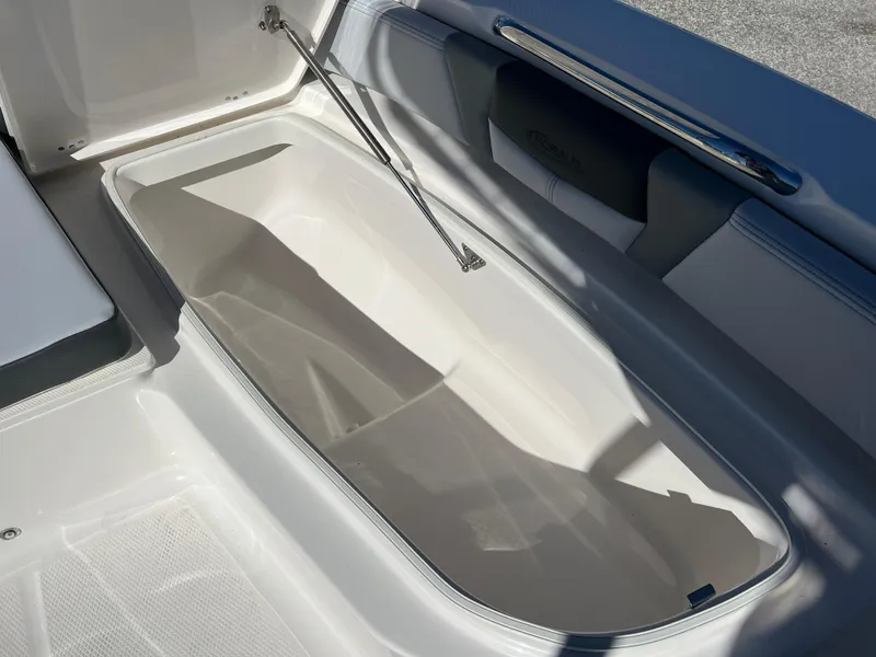 Slide: The Image of 2025 Robalo 206 Cayman boat storage compartment, open lid, interior view. - 22