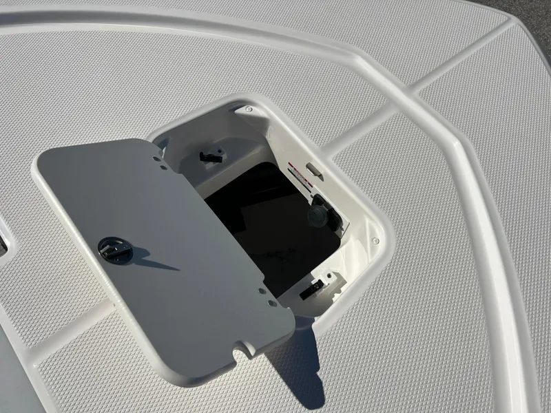 Slide: The Image of 2025 Robalo 206 Cayman boat hatch detail with textured deck surface. - 24