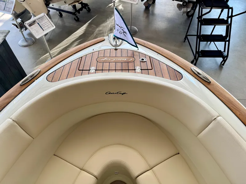 Slide: The Image of 2025 Chris-Craft Launch 27 boat interior with elegant wood and leather detailing. - 11