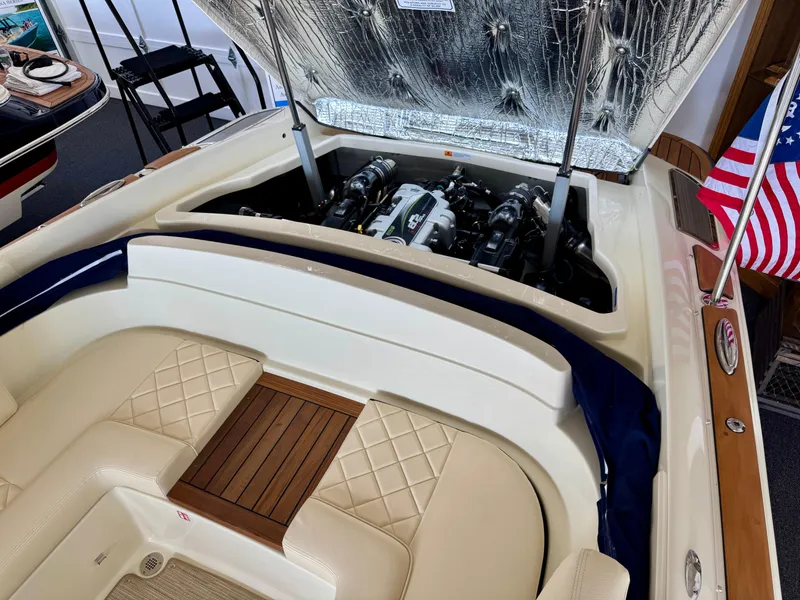 Slide: The Image of 2025 Chris-Craft Launch 27 boat interior with open engine compartment and American flag. - 13