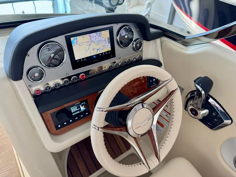 Slide: The Image of 2025 Chris-Craft Launch 27 dashboard with steering wheel and navigation display. - 8