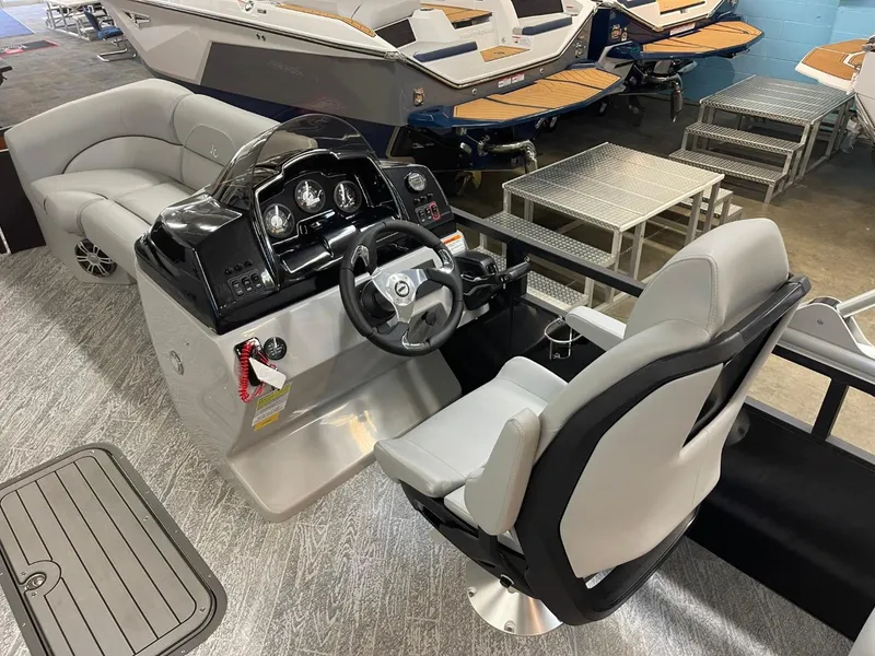 Slide: The Image of 2025 JC Spirit 247TT Sport boat interior with modern helm and seating. - 11