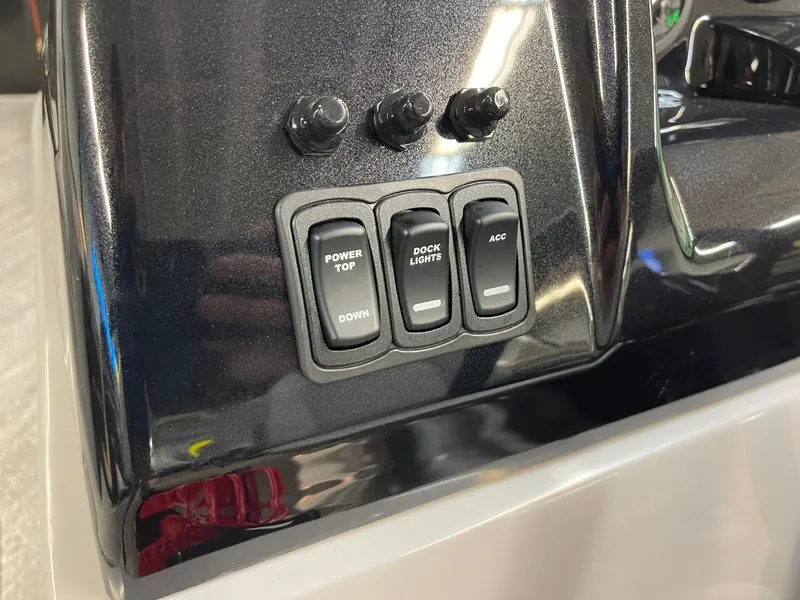 Slide: The Image of Control panel of 2025 JC Spirit 247TT Sport with switches for power top and dock lights. - 14