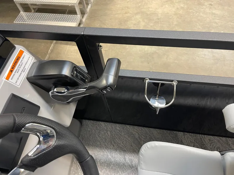 Slide: The Image of 2025 JC Spirit 247TT Sport boat interior with steering wheel and throttle controls. - 15
