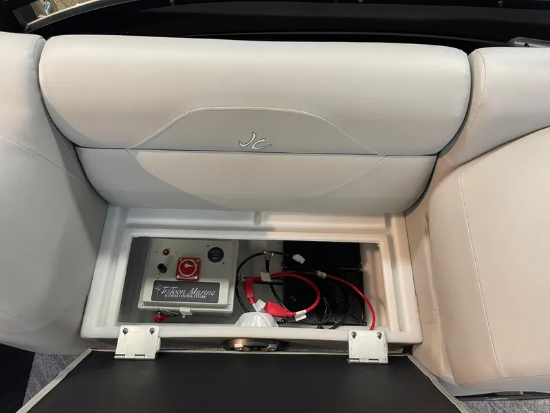 Slide: The Image of 2025 JC Spirit 247TT Sport boat seat storage with electrical components. - 23