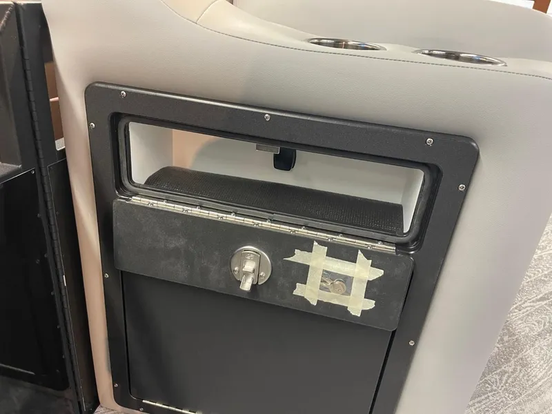 Slide: The Image of 2025 JC Spirit 247TT Sport interior storage compartment with taped lock mechanism. - 26