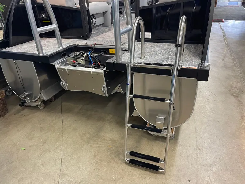 Slide: The Image of 2025 JC Spirit 247TT Sport boat with ladder and exposed engine components. - 31