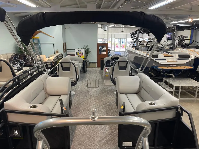 Slide: The Image of 2025 JC Spirit 247TT Sport pontoon boat interior with plush seating in showroom. - 32
