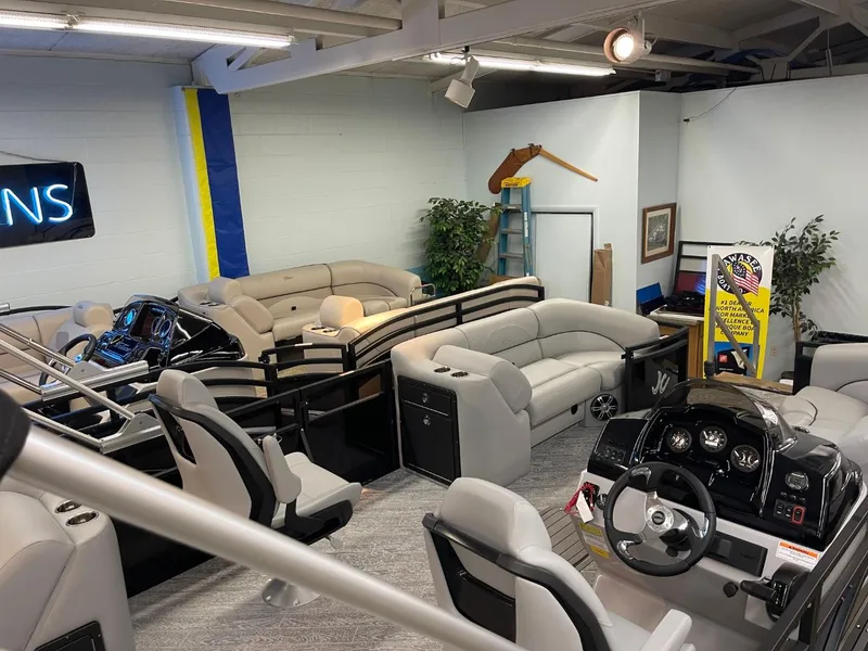 Slide: The Image of 2025 JC Spirit 247TT Sport boat interior in showroom with seating and control panel. - 33