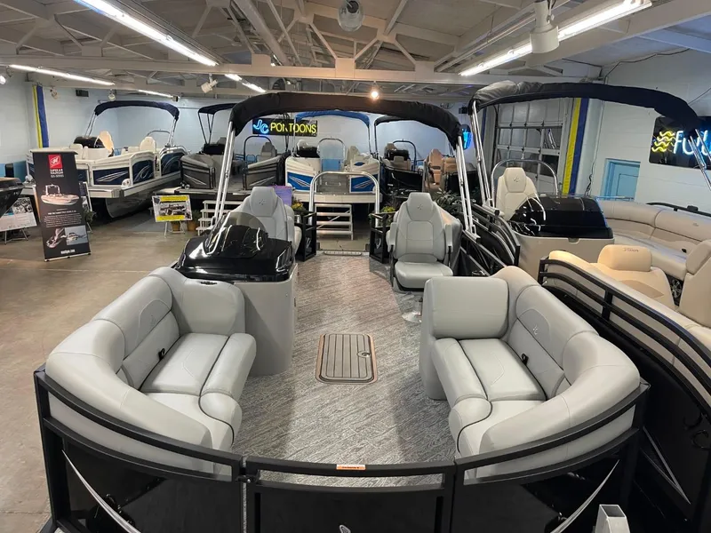 Slide: The Image of 2025 JC Spirit 247TT Sport pontoon boat in showroom with luxurious seating. - 35