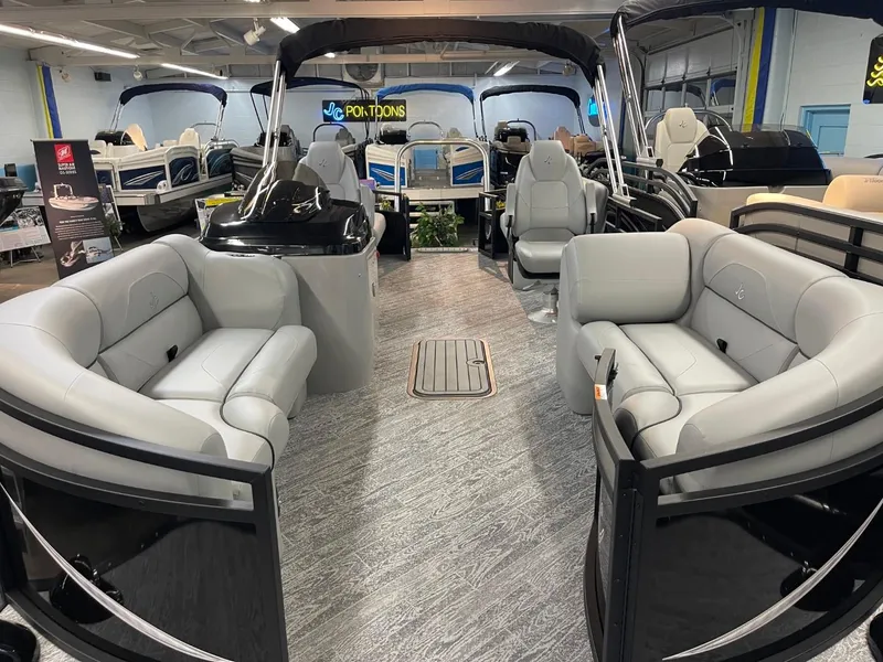 Slide: The Image of 2025 JC Spirit 247TT Sport pontoon boat interior with luxurious seating in showroom. - 4