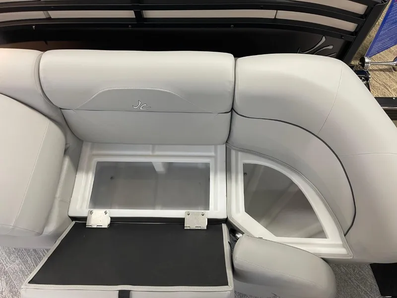 Slide: The Image of 2025 JC Spirit 247TT Sport boat interior with storage compartments and sleek seating design. - 6