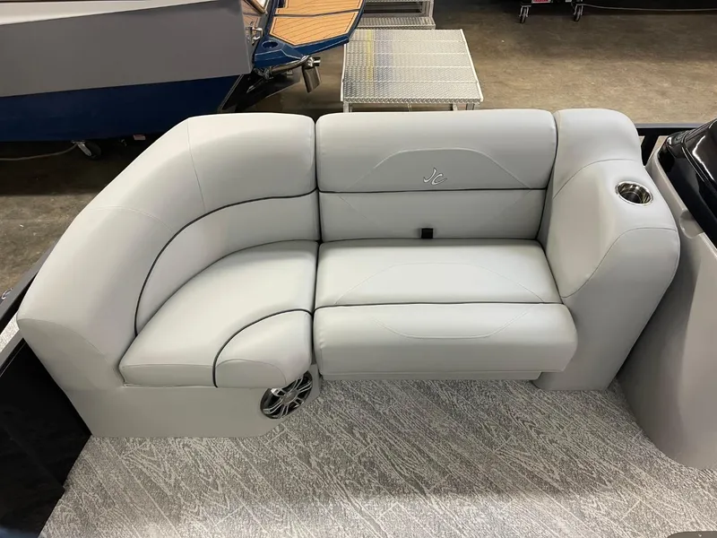 Slide: The Image of 2025 JC Spirit 247TT Sport boat interior with plush seating and cup holder. - 7