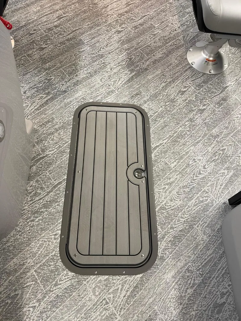 Slide: The Image of 2025 JC Spirit 247TT Sport boat interior with sleek flooring and hatch. - 9