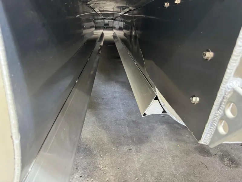 Slide: The Image of Interior view of 2025 JC Swingback 25 TT pontoon, showcasing metal construction details. - 12