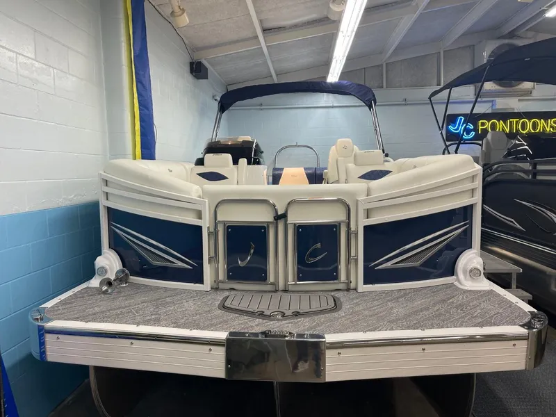 Slide: The Image of 2025 JC Swingback 25 TT pontoon boat in showroom, rear view. - 14