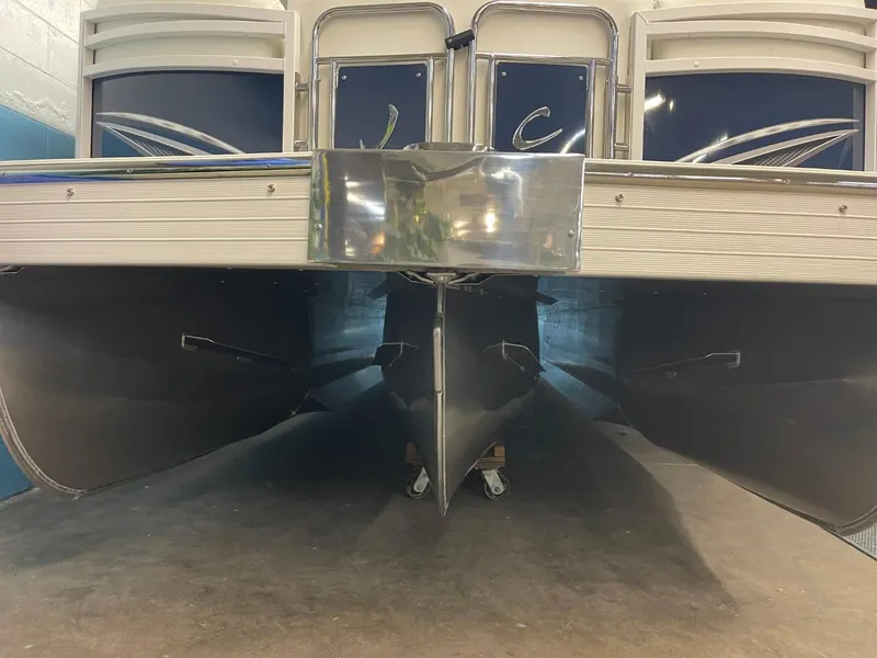 Slide: The Image of 2025 JC Swingback 25 TT pontoon boat, front view, showcasing sleek design and structure. - 15