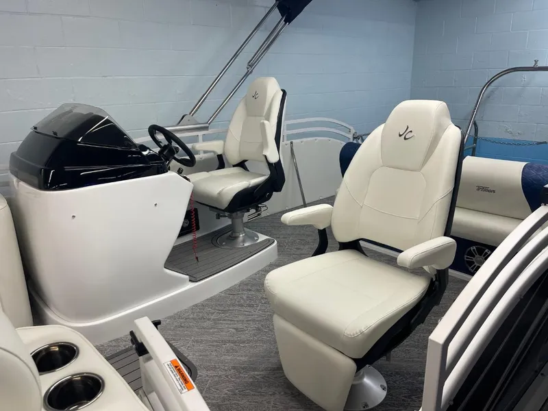 Slide: The Image of 2025 JC Swingback 25 TT boat interior with white leather seats and modern helm. - 17