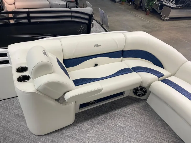 Slide: The Image of Luxurious seating on 2025 JC Swingback 25 TT pontoon boat with cup holders and blue accents. - 19