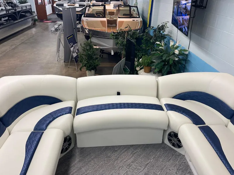 Slide: The Image of Luxurious seating on 2025 JC Swingback 25 TT boat in showroom setting. - 20