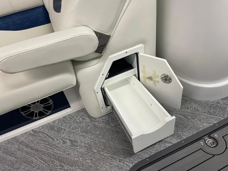 Slide: The Image of 2025 JC Swingback 25 TT boat interior with open storage compartment and white seating. - 22