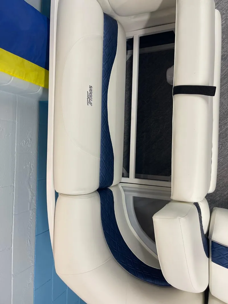 Slide: The Image of 2025 JC Swingback 25 TT boat seating with white and blue upholstery. - 25